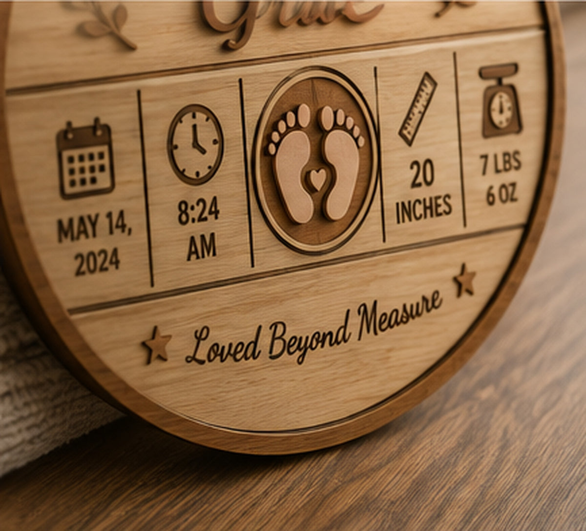 Close-up of engraved birth details and layered wood craftsmanship on baby keepsake