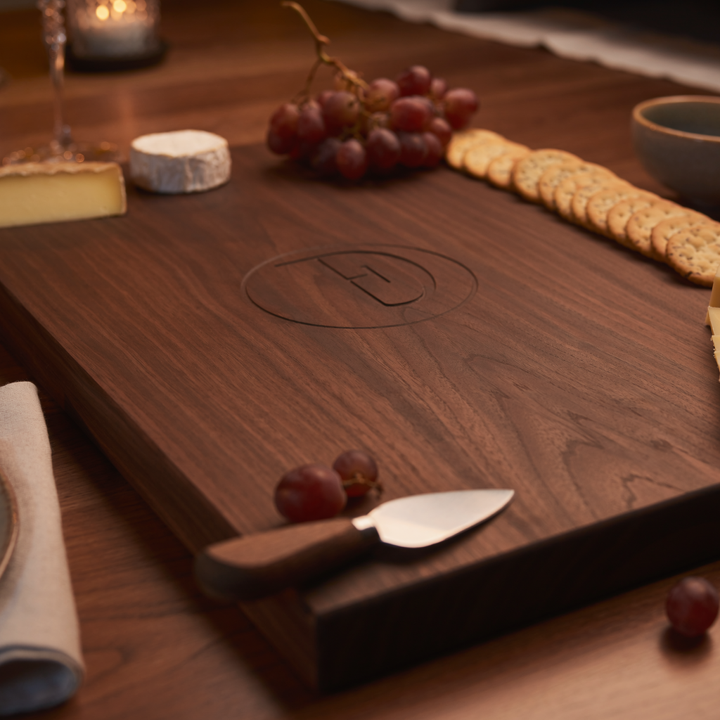 Personalized dark walnut charcuterie serving board styled for elegant entertaining