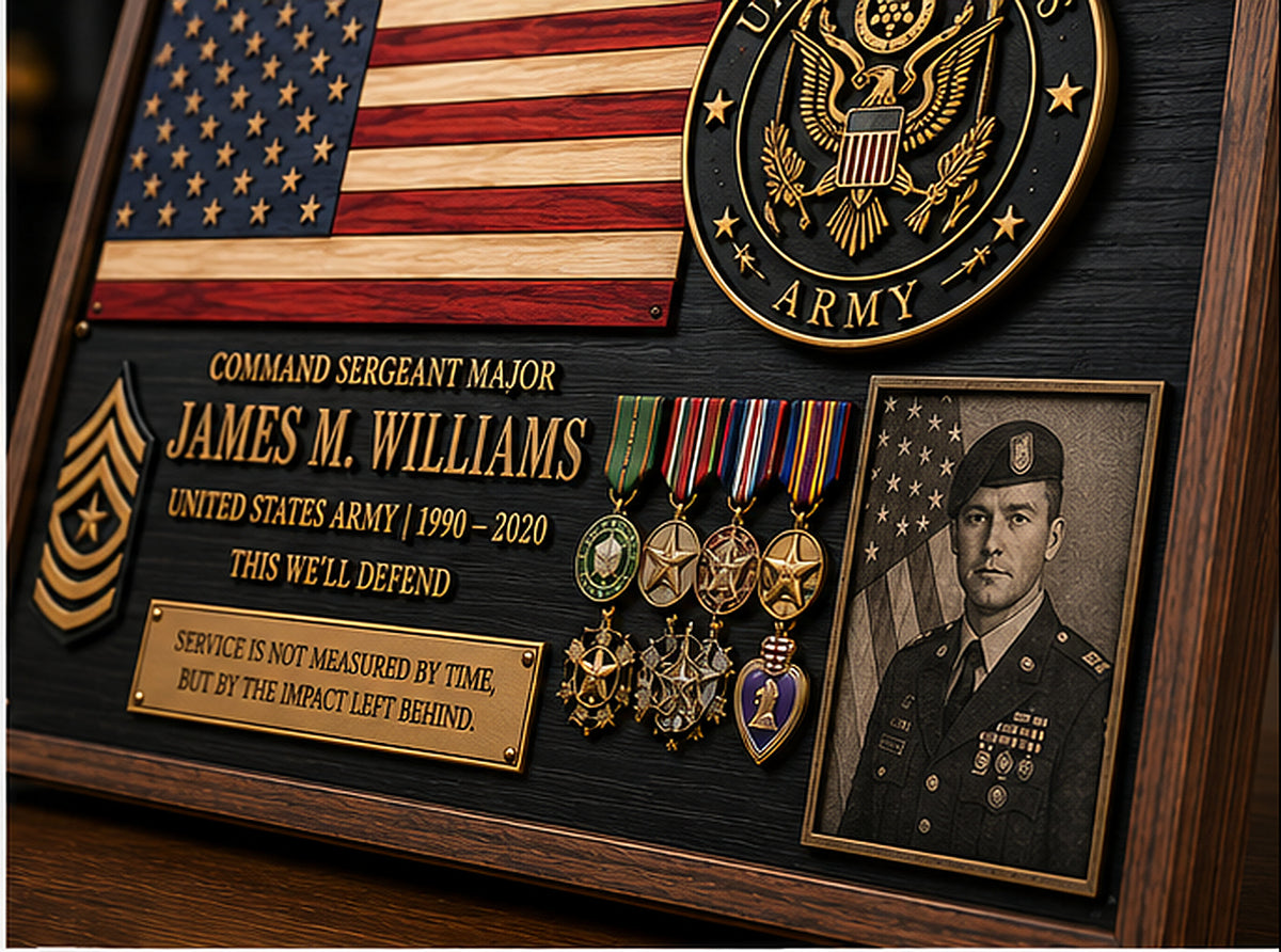 Close-up of military tribute plaque showing detailed medals, service lettering and grayscale laser-engraved portrait