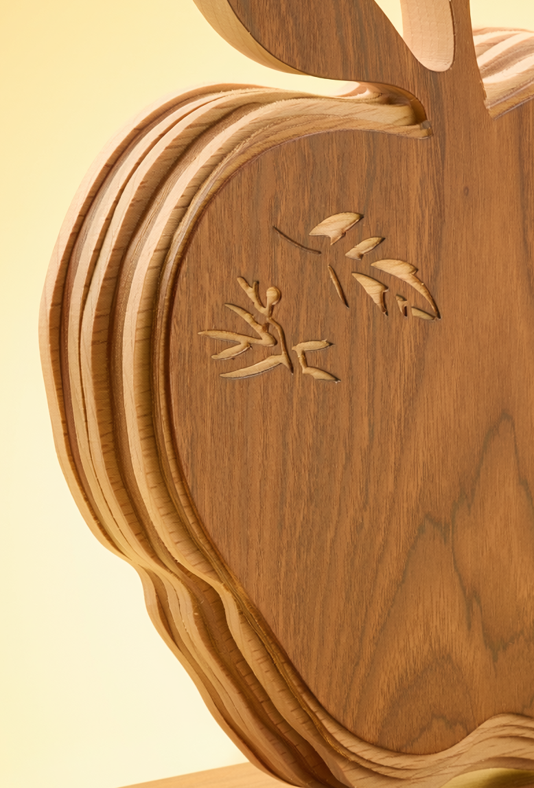 Close-up of layered wood construction and engraved detail on teacher appreciation apple heirloom